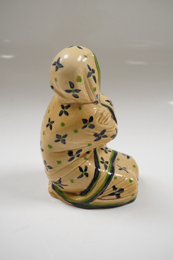 An Ashtead pottery figure of a kneeling ‘eastern lady’, stamped to the base, 15cm high